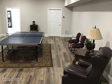 9743 Lower Thomaston Road Macon, GA 31220 - Photo 25 of 28 a living room with furniture and a fireplace