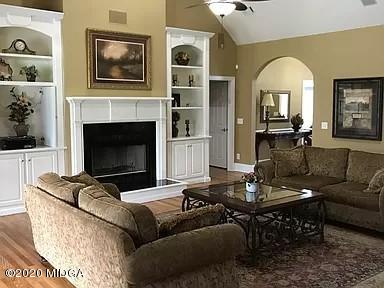 9743 Lower Thomaston Road Macon, GA 31220 - Photo 5 of 28 a living room with furniture a fireplace and a flat screen tv