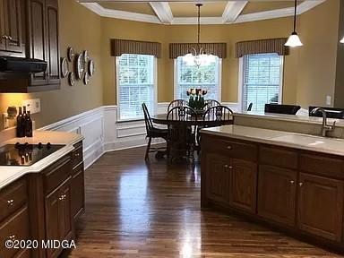 9743 Lower Thomaston Road Macon, GA 31220 - Photo 9 of 28 a kitchen with a table chairs and wooden floor