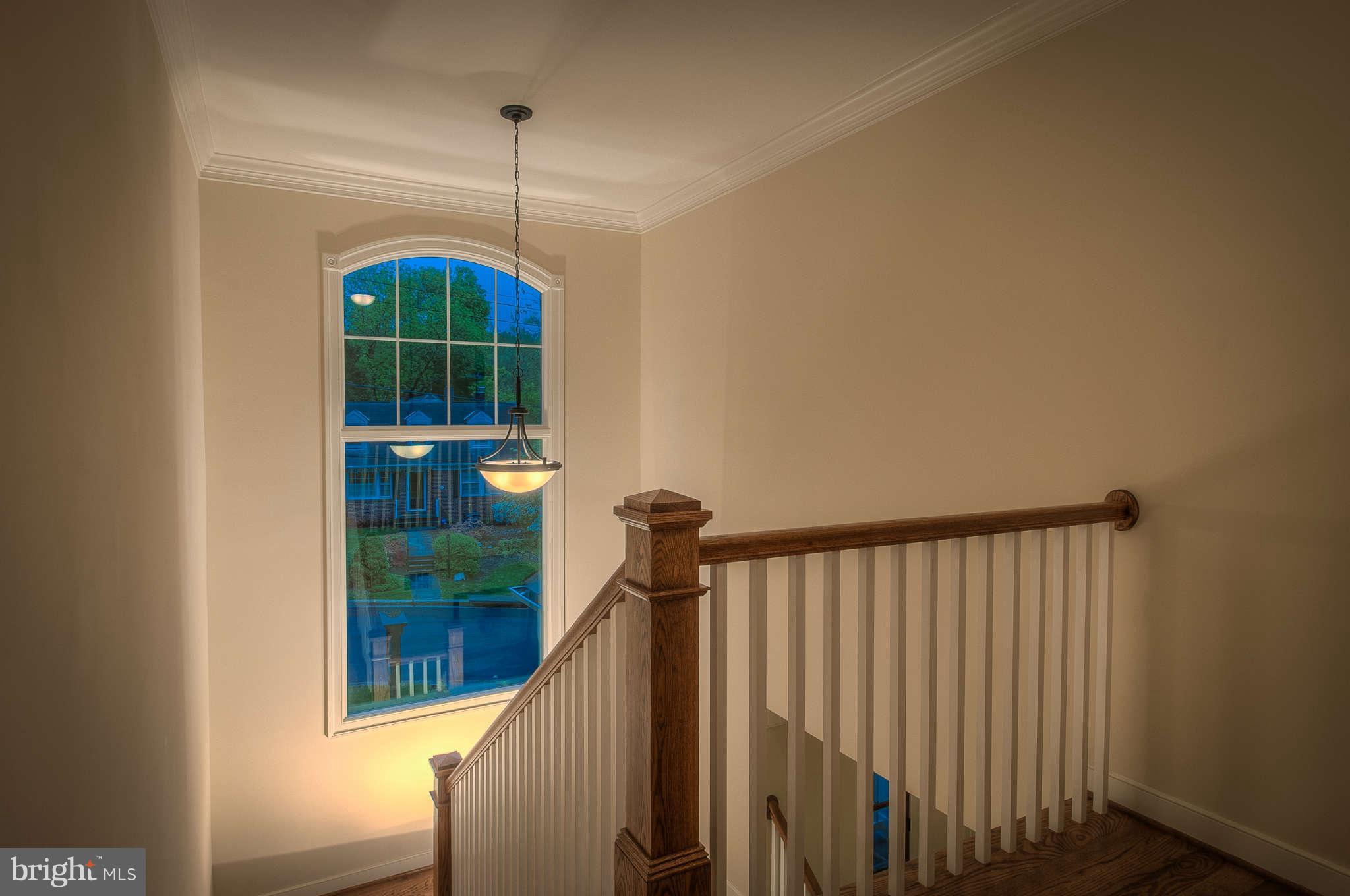 8700 Melwood Road Bethesda, MD 20817 - Photo 11 of 13 a view of a hallway with windows and stairs