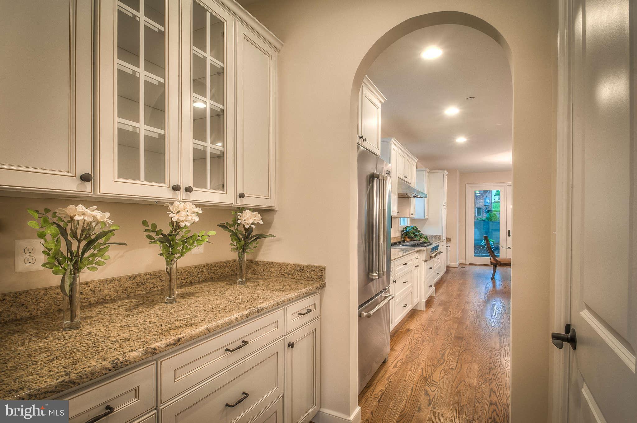 8700 Melwood Road Bethesda, MD 20817 - Photo 4 of 13 a view of a kitchen with granite countertop a sink and cabinets