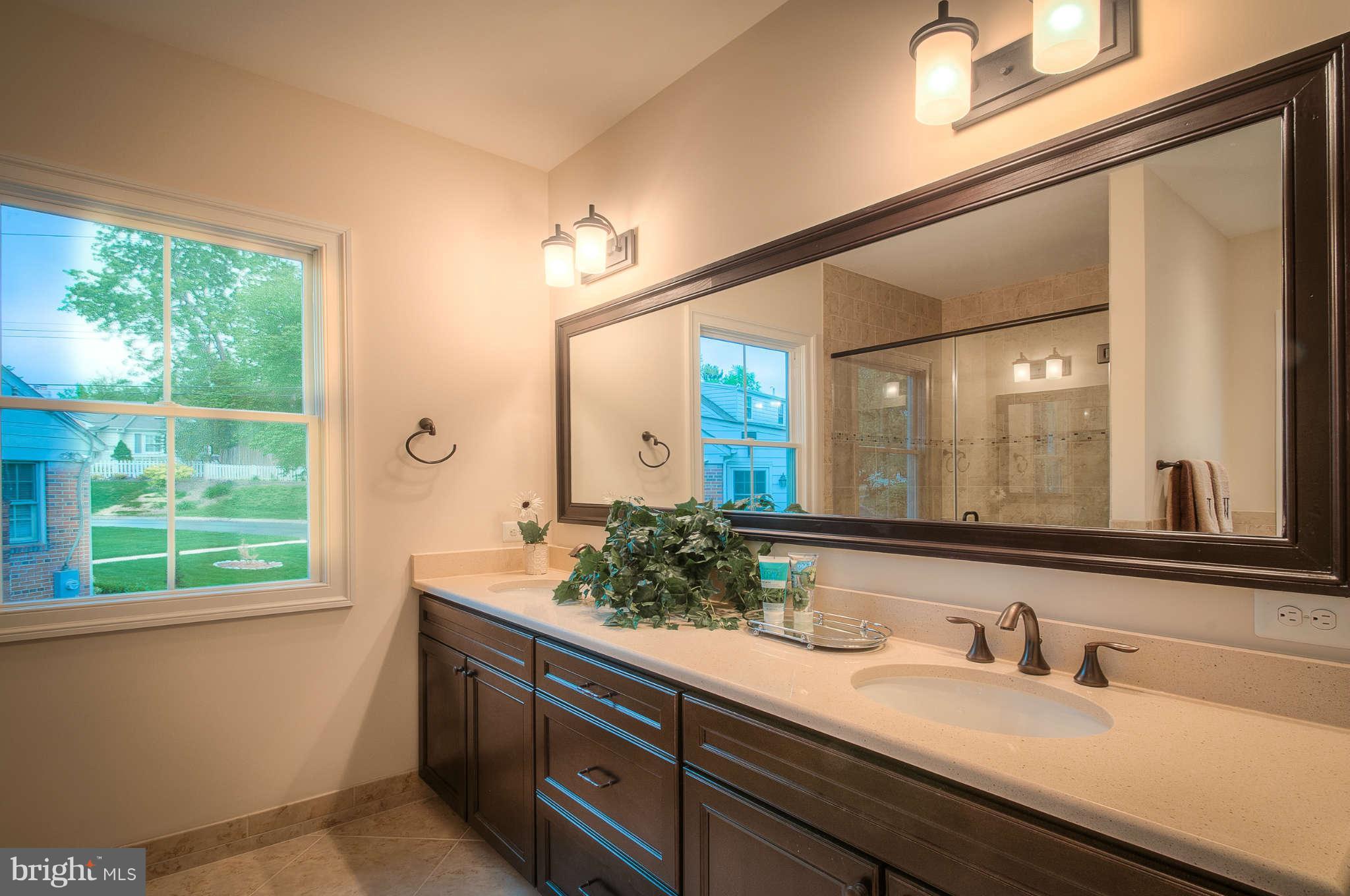8700 Melwood Road Bethesda, MD 20817 - Photo 8 of 13 a bathroom with a granite countertop sink and a large mirror