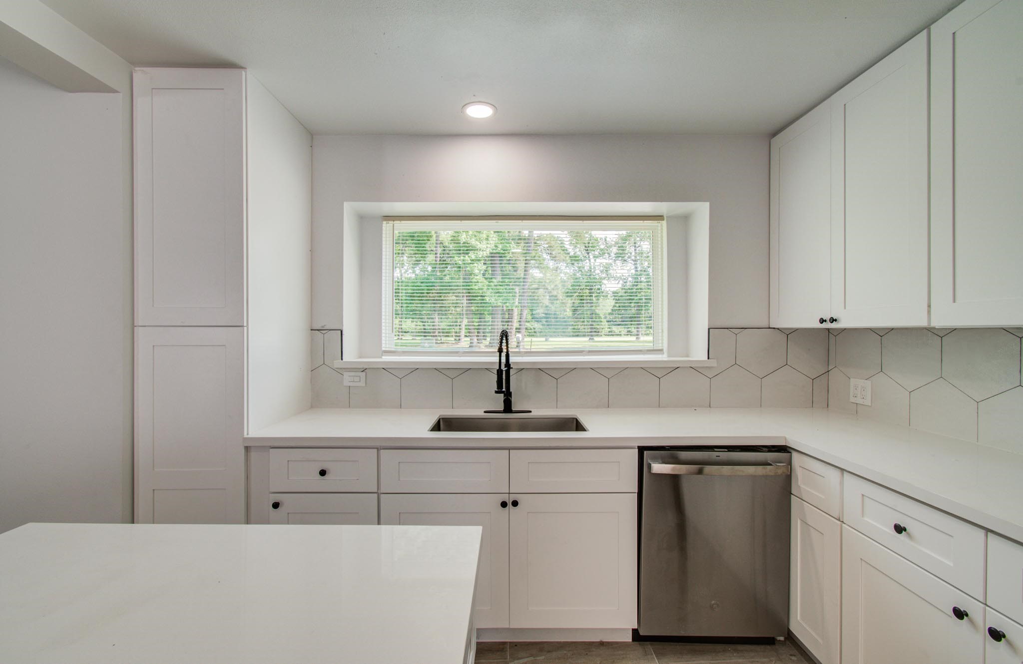494 Brandon Road Conroe, TX 77302 - Photo 6 of 22 a kitchen with cabinets appliances a sink and a window