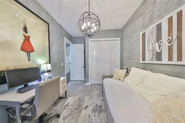 a living room with furniture wooden floor and a flat screen tv