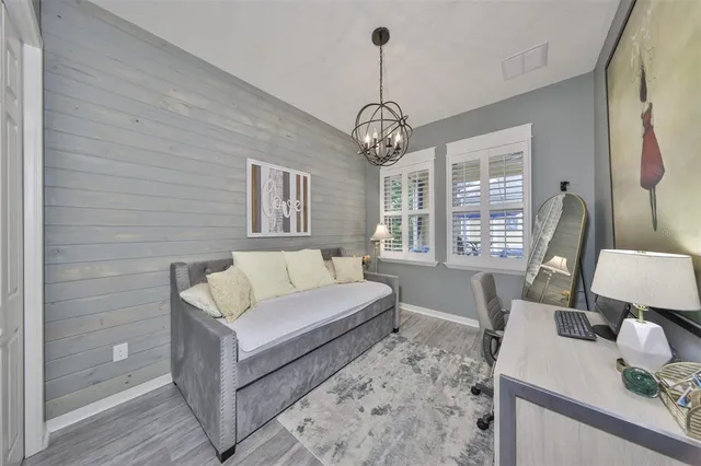 a living room with furniture a lamp and a large window