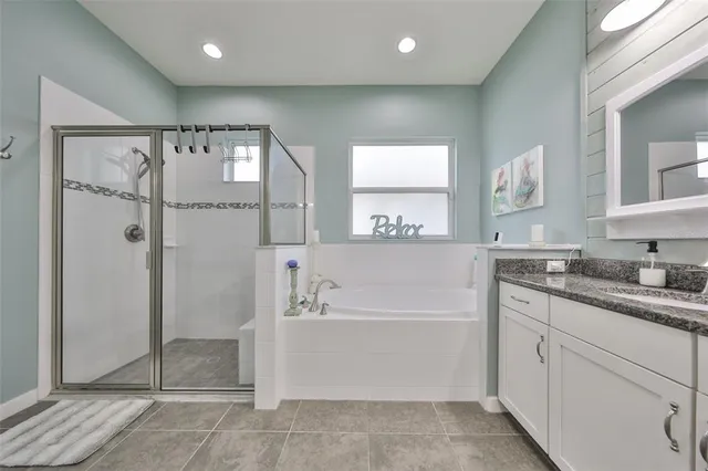 a bedroom with a bed a dresser and chair