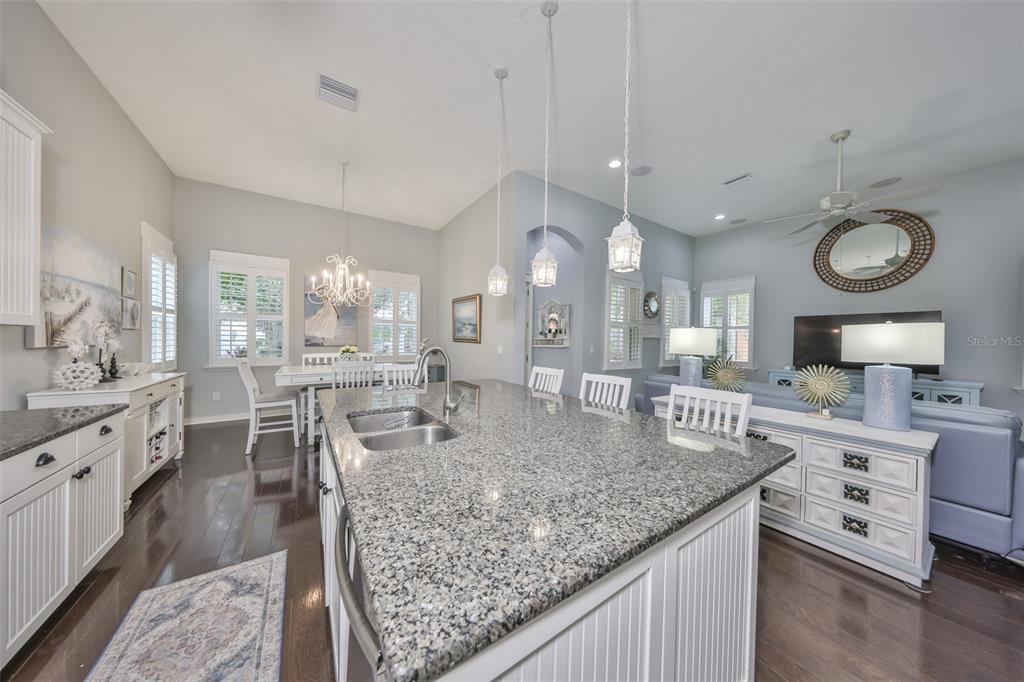 511 Winterside Drive Apollo Beach, FL 33572 - Photo 3 of 72 a large kitchen with kitchen island a table and chairs in it