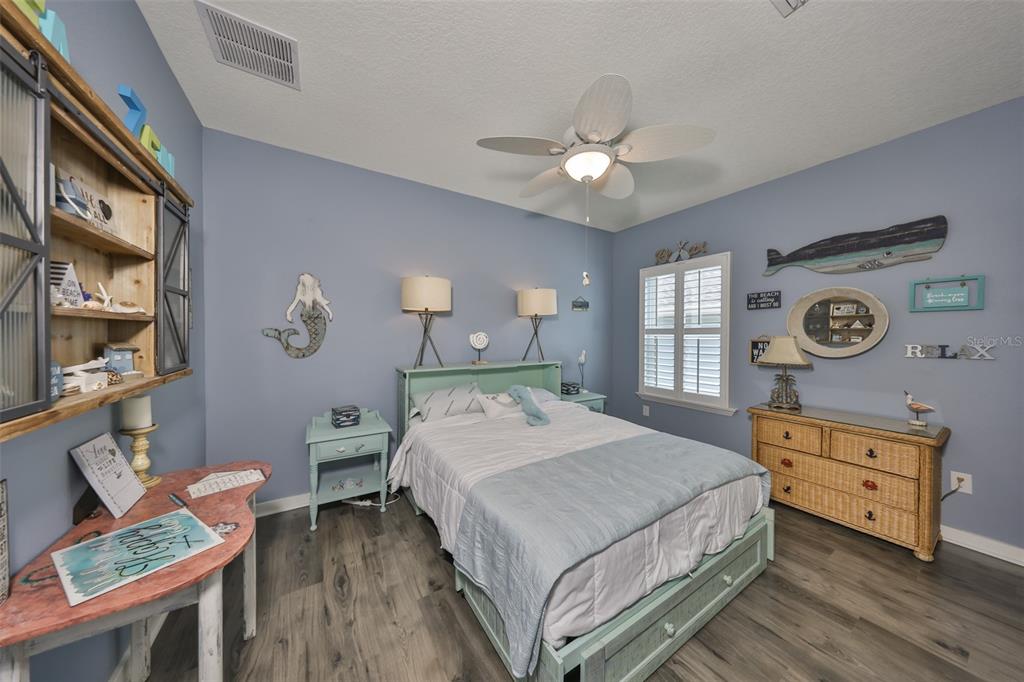511 Winterside Drive Apollo Beach, FL 33572 - Photo 32 of 72 a bedroom with a bed a dresser and chair
