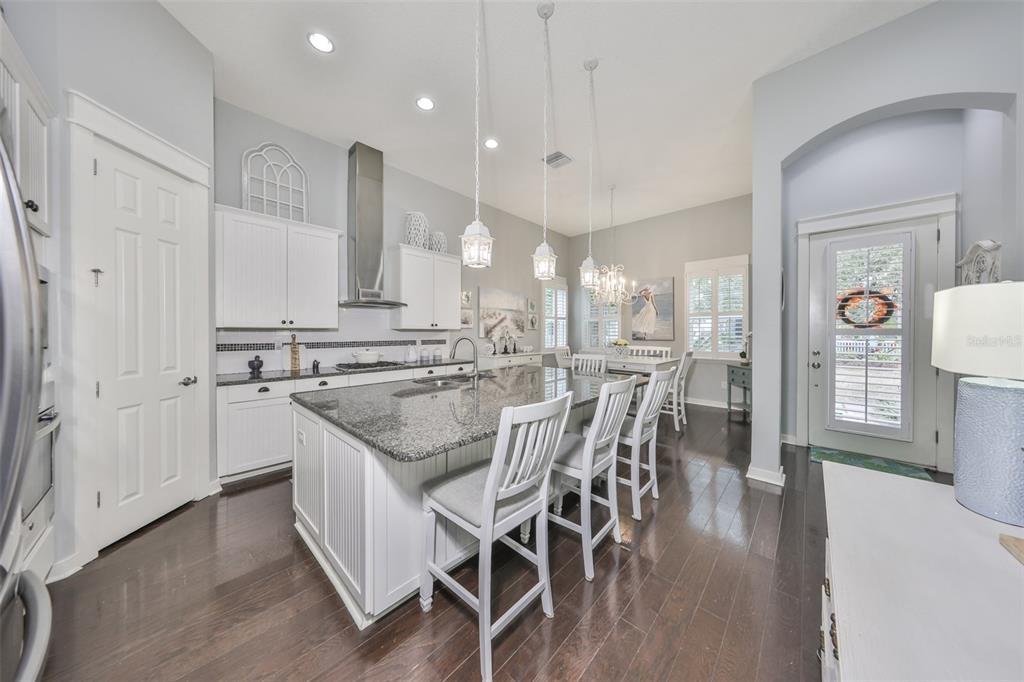 511 Winterside Drive Apollo Beach, FL 33572 - Photo 4 of 72 a kitchen with stainless steel appliances granite countertop a kitchen island a stove a table and chairs in it