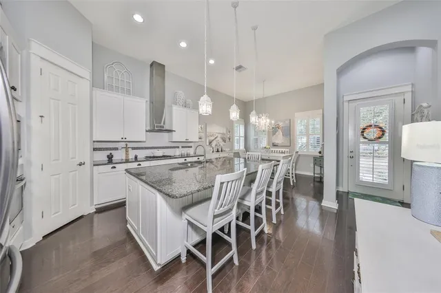 a view of a kitchen with kitchen island a sink appliances and a counter space