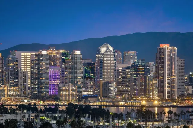 a living room with furniture a wooden floor and a large window