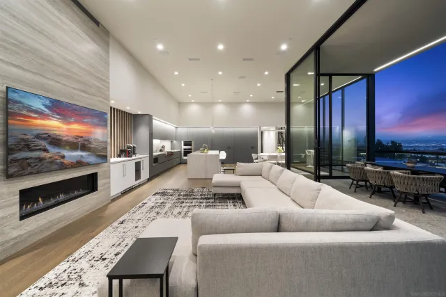 a bedroom with a bed a couch and a potted plant with wooden floor