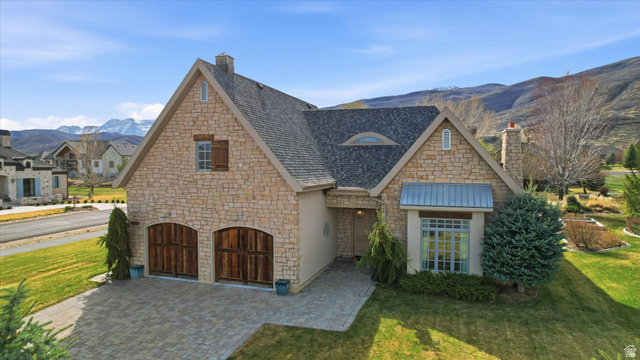930 Price Farm Court Midway, UT 84049 - Photo 8 of 42 View of front facade with a mountain view, stone siding, a front lawn, and a chimney