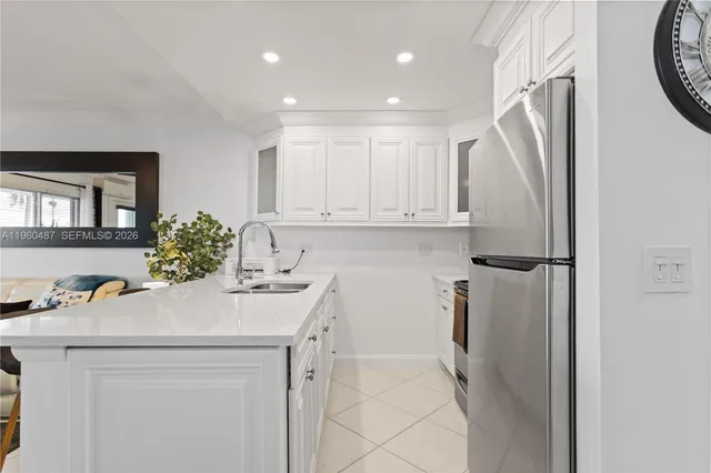 a kitchen with a sink appliances and cabinets
