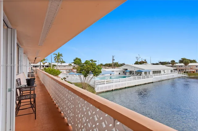 a view of swimming pool with outdoor seating and lake