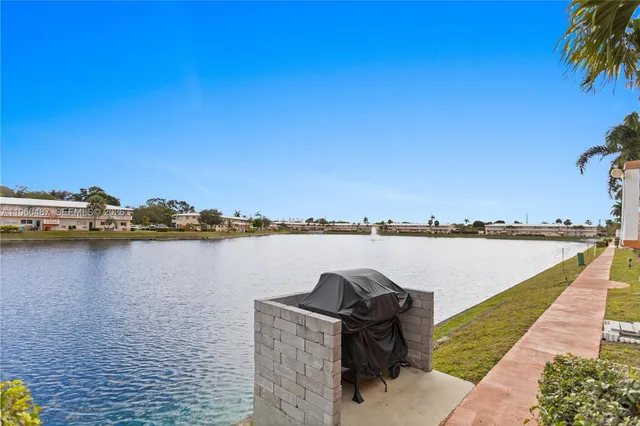 a view of a lake with a table and chairs