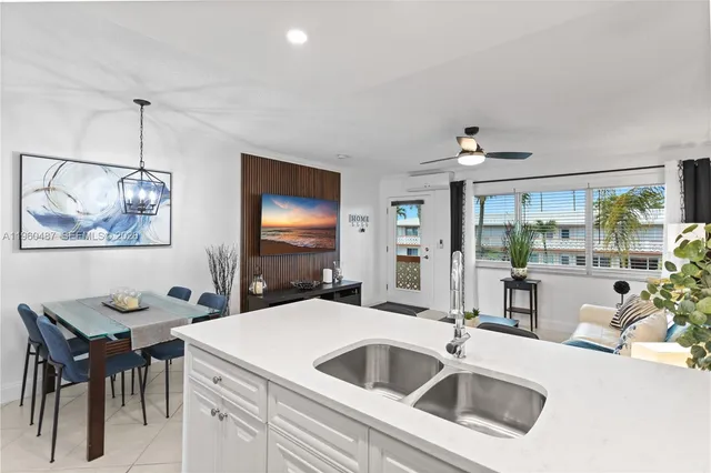 a kitchen with a sink cabinets and wooden floor