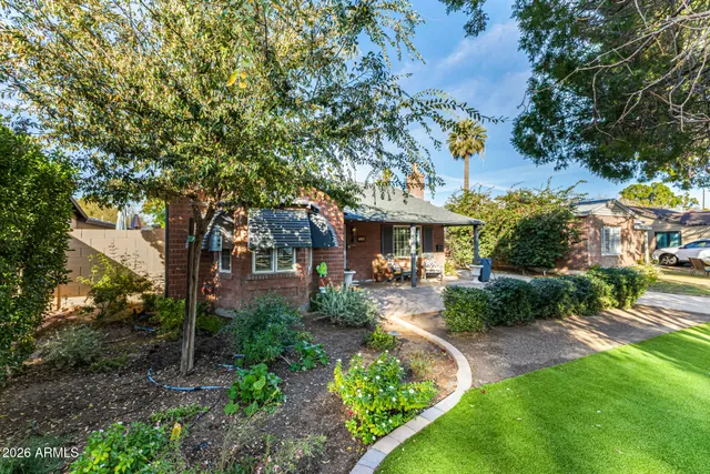 a view of a patio with table and chairs under an umbrella