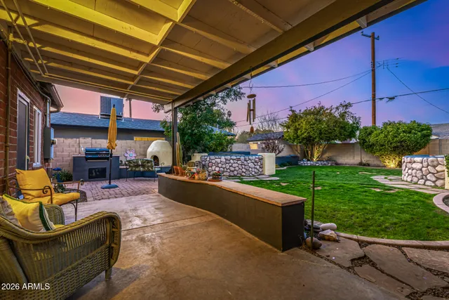 a view of a backyard with plants and a patio
