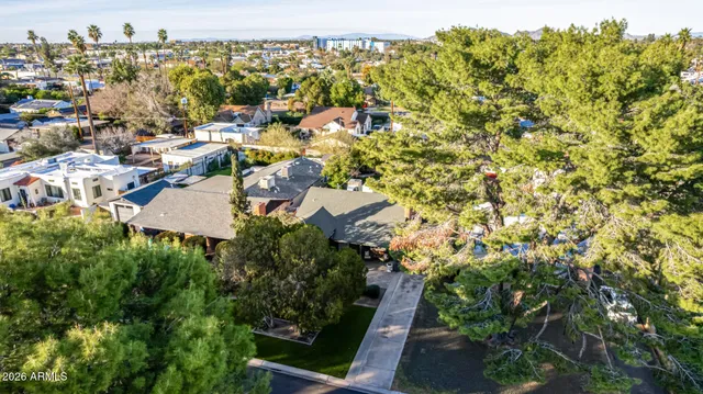 an aerial view of a house with a garden and pool