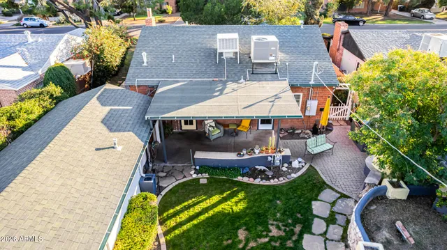 an aerial view of a house with a swimming pool yard and mountain view in back