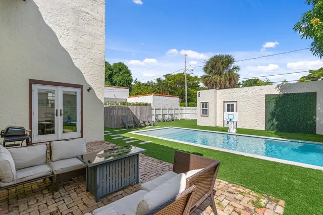 a view of backyard with seating area and green space