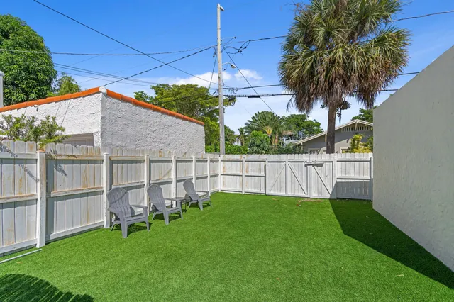 a house view with a sitting space and garden