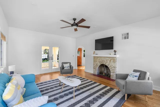 a living room with furniture a fireplace and a flat screen tv