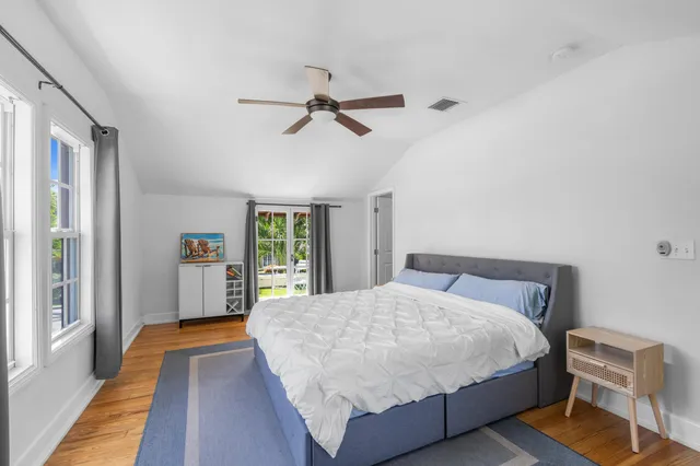 a bedroom with a large bed and a chandelier
