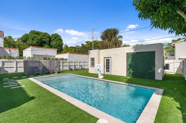 a view of an house with backyard space and a tree