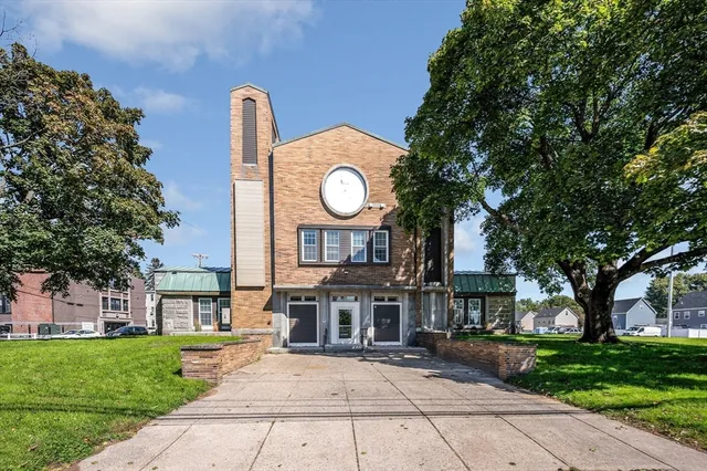 a view of a big room with a big yard and large trees