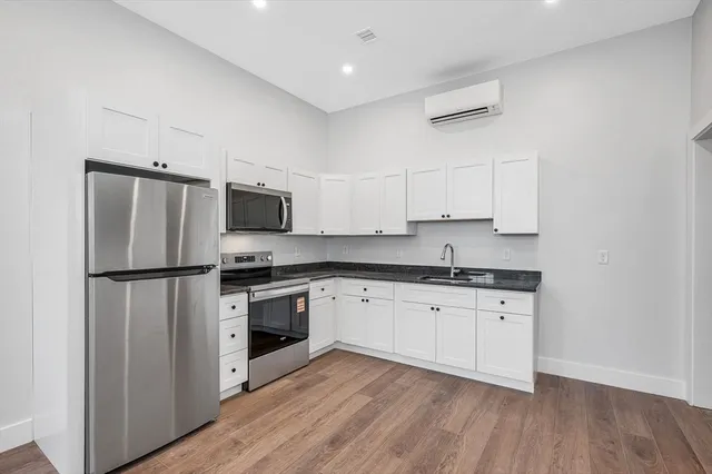 a kitchen with stainless steel appliances a refrigerator sink and microwave