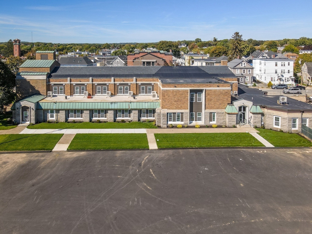 241 West 6th Street, Unit 102 Lowell, MA 01850 - Photo 23 of 25 a view of a big room with a big yard and large trees