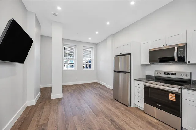 a kitchen with stainless steel appliances a stove a microwave and cabinets