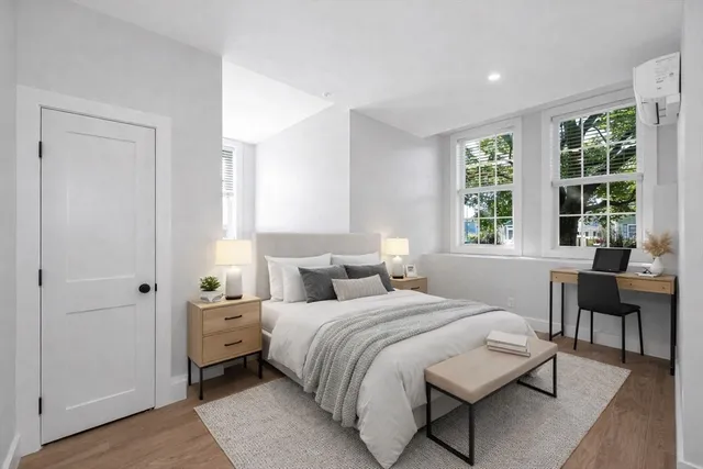 a bedroom with a bed and a window