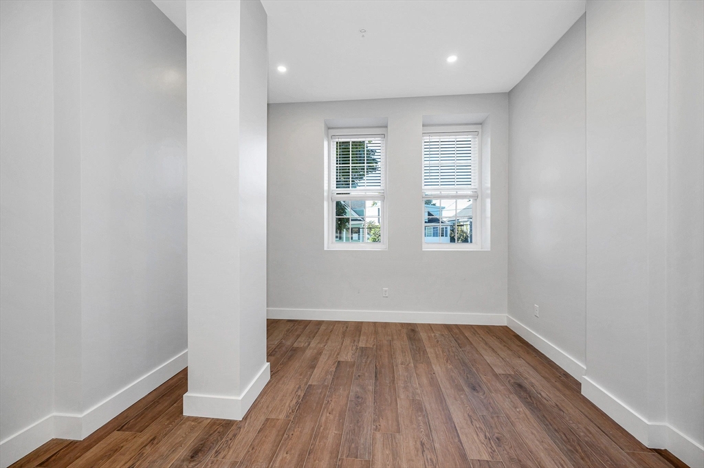241 West 6th Street, Unit 102 Lowell, MA 01850 - Photo 5 of 25 a view of a room with wooden floor and windows