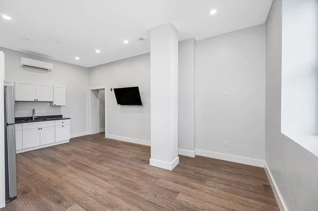 a view of a kitchen with wooden floor and a sink
