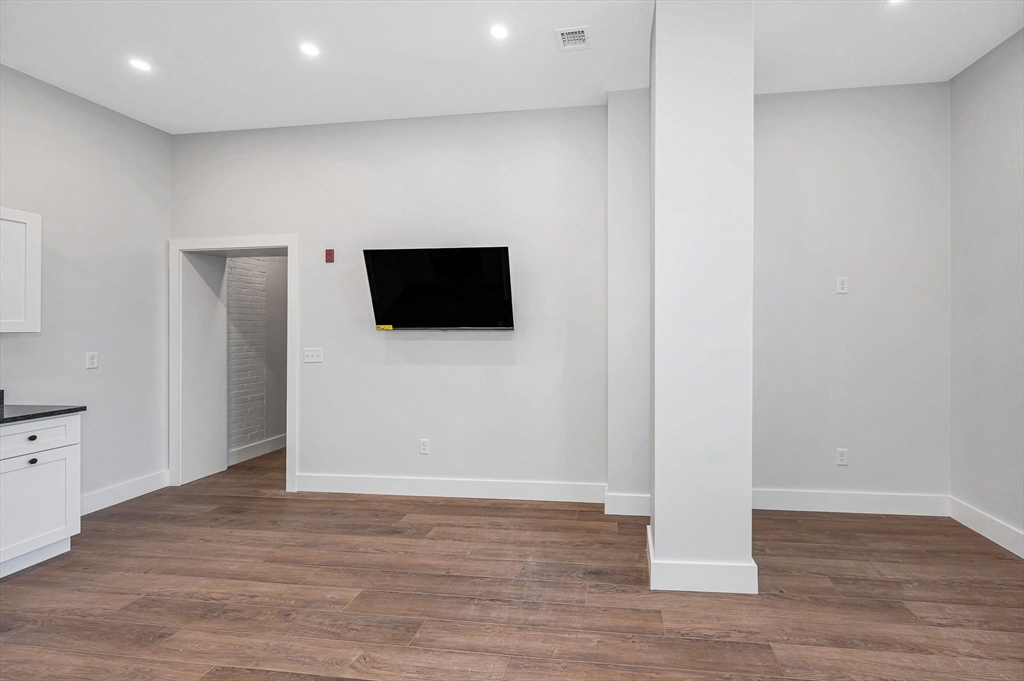241 West 6th Street, Unit 102 Lowell, MA 01850 - Photo 7 of 25 a view of a livingroom with wooden floor