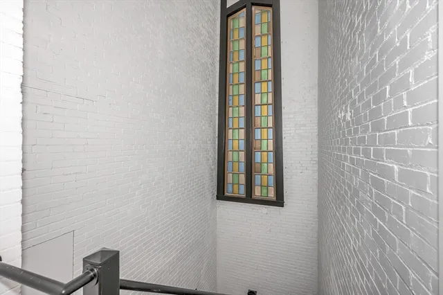 a bathroom with a window and a shower