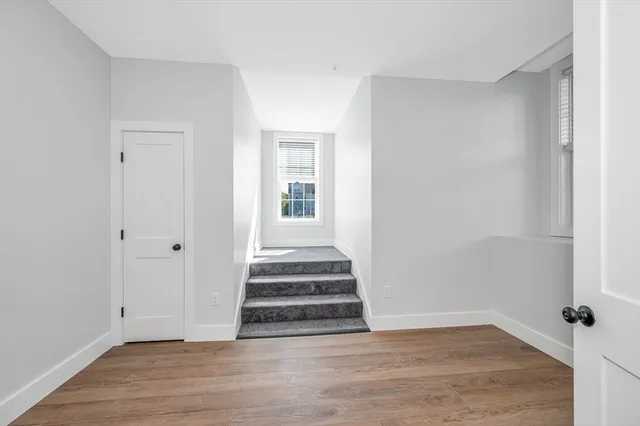 a view of an entryway with wooden floor