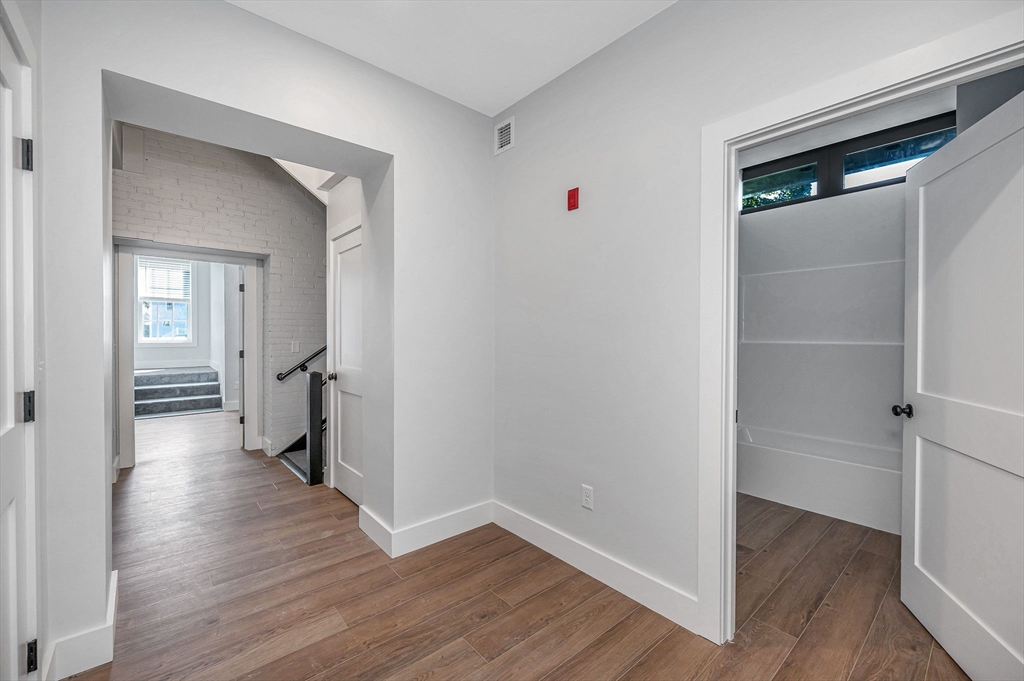 241 West 6th Street, Unit 102 Lowell, MA 01850 - Photo 10 of 25 a view of a hallway with wooden floor and closet