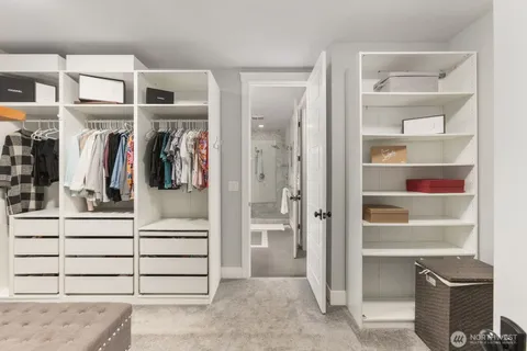 a spacious bathroom with a double vanity sink a large mirror and a bathtub