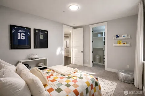 a bedroom with a bed and a large window