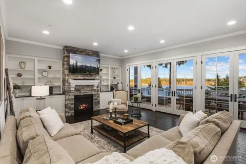 a living room with furniture and a dining table with kitchen view