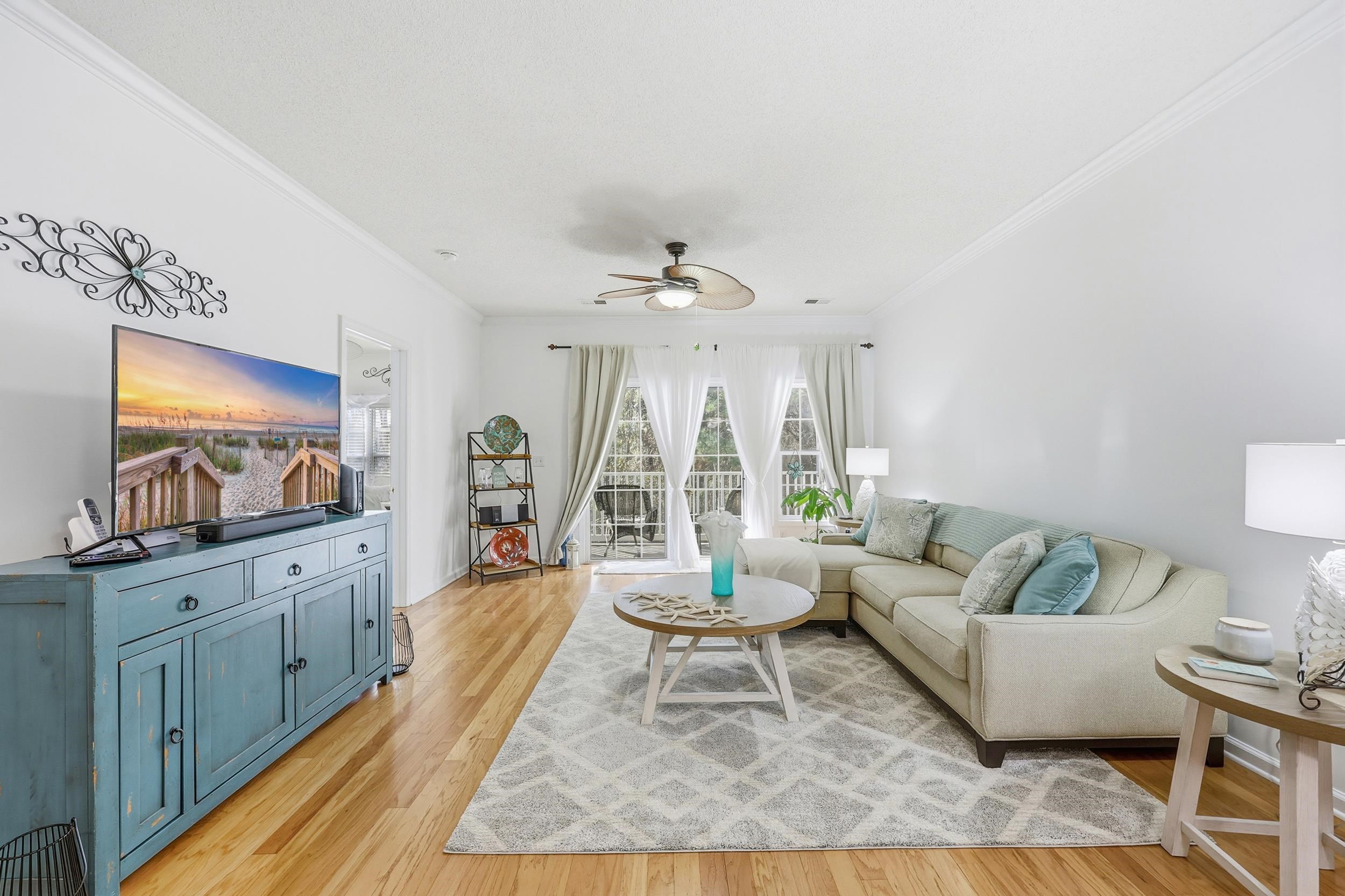 5870 Longwood Drive, Unit 203 Murrells Inlet, SC 29576 - Photo 15 of 32 Living area featuring ceiling fan, ornamental molding, and light wood-type flooring
