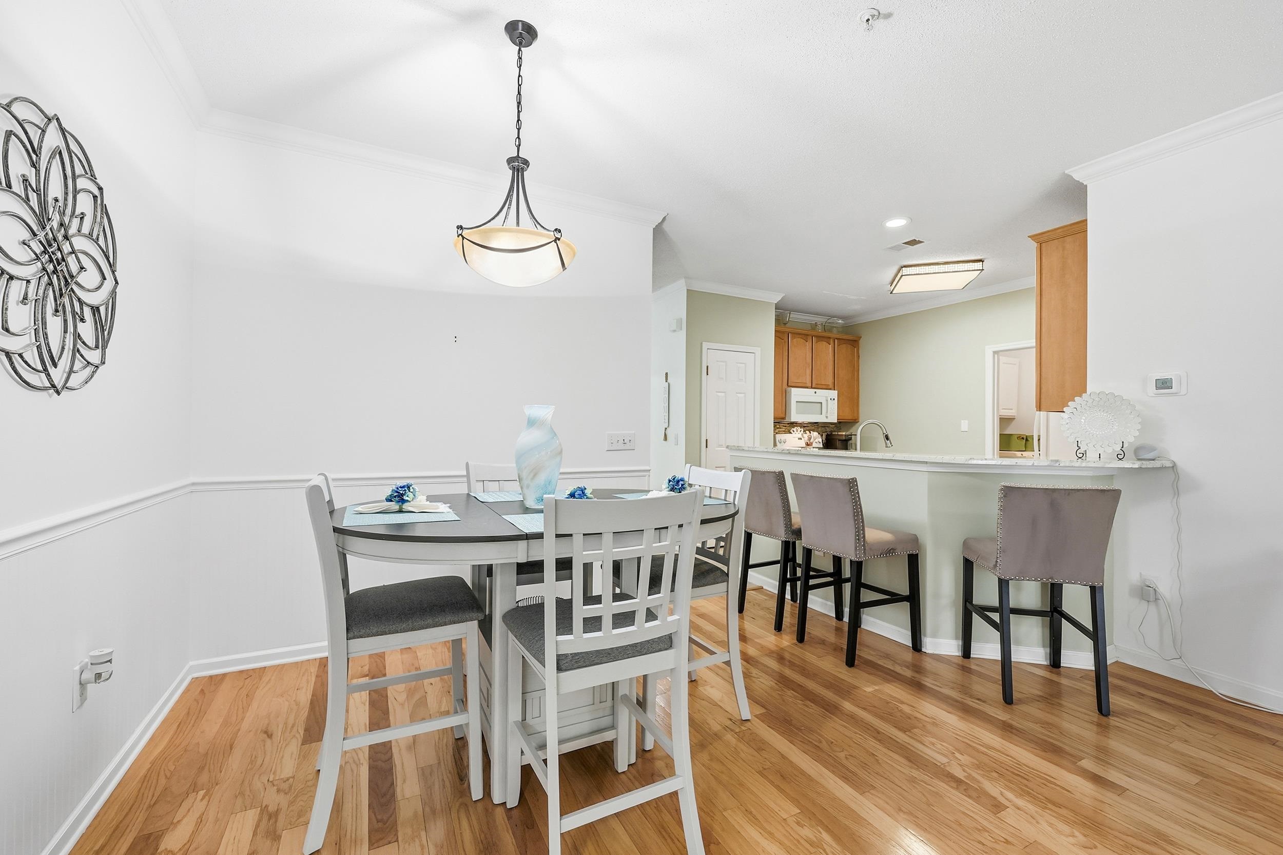 5870 Longwood Drive, Unit 203 Murrells Inlet, SC 29576 - Photo 16 of 32 Dining area with crown molding, light wood-style floors, and recessed lighting
