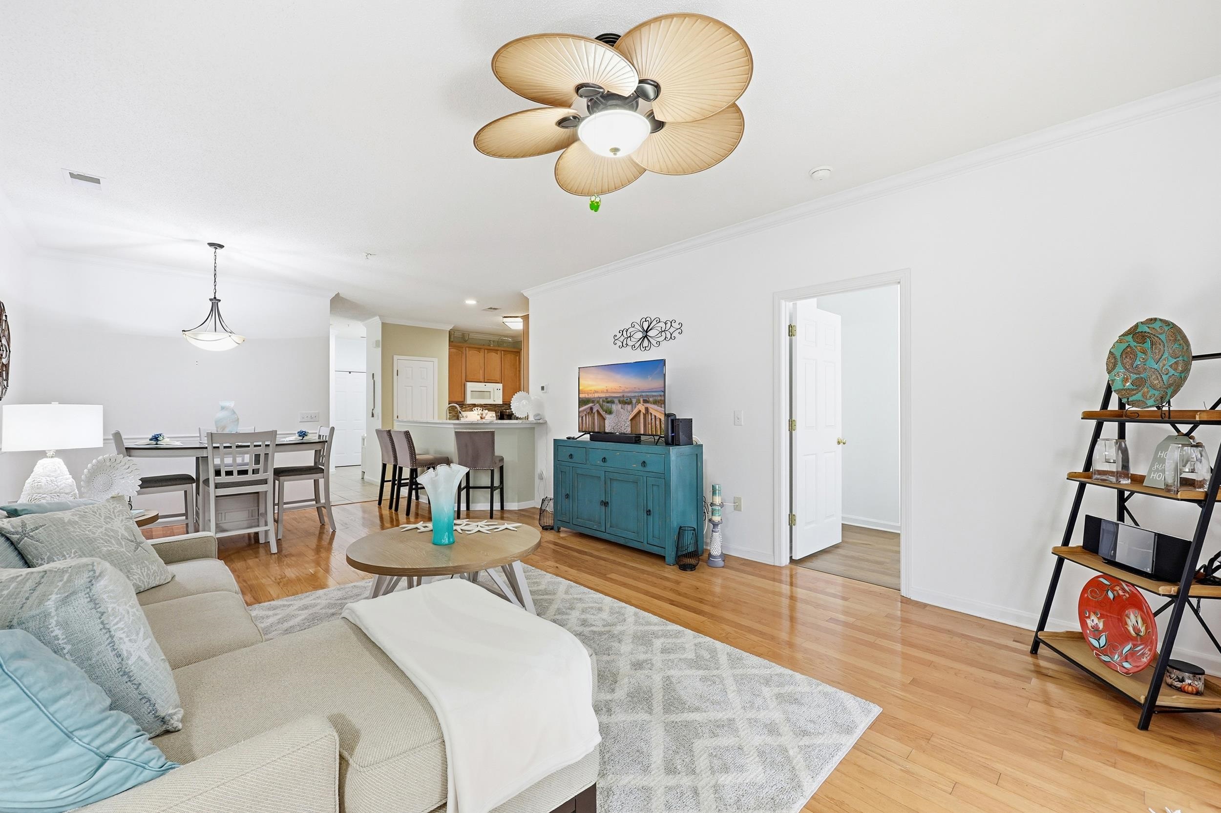 5870 Longwood Drive, Unit 203 Murrells Inlet, SC 29576 - Photo 18 of 32 Living room with light wood-type flooring, crown molding, and a ceiling fan