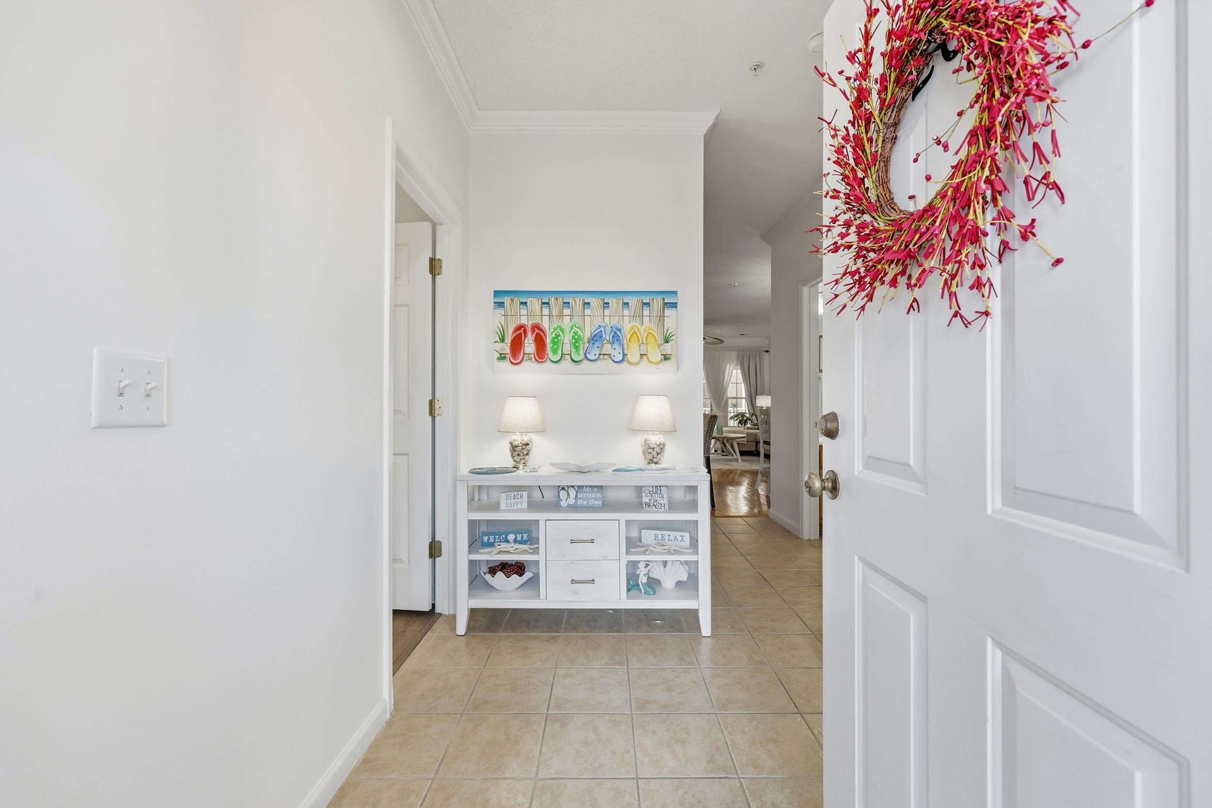 5870 Longwood Drive, Unit 203 Murrells Inlet, SC 29576 - Photo 3 of 32 Corridor with ornamental molding and light tile patterned floors