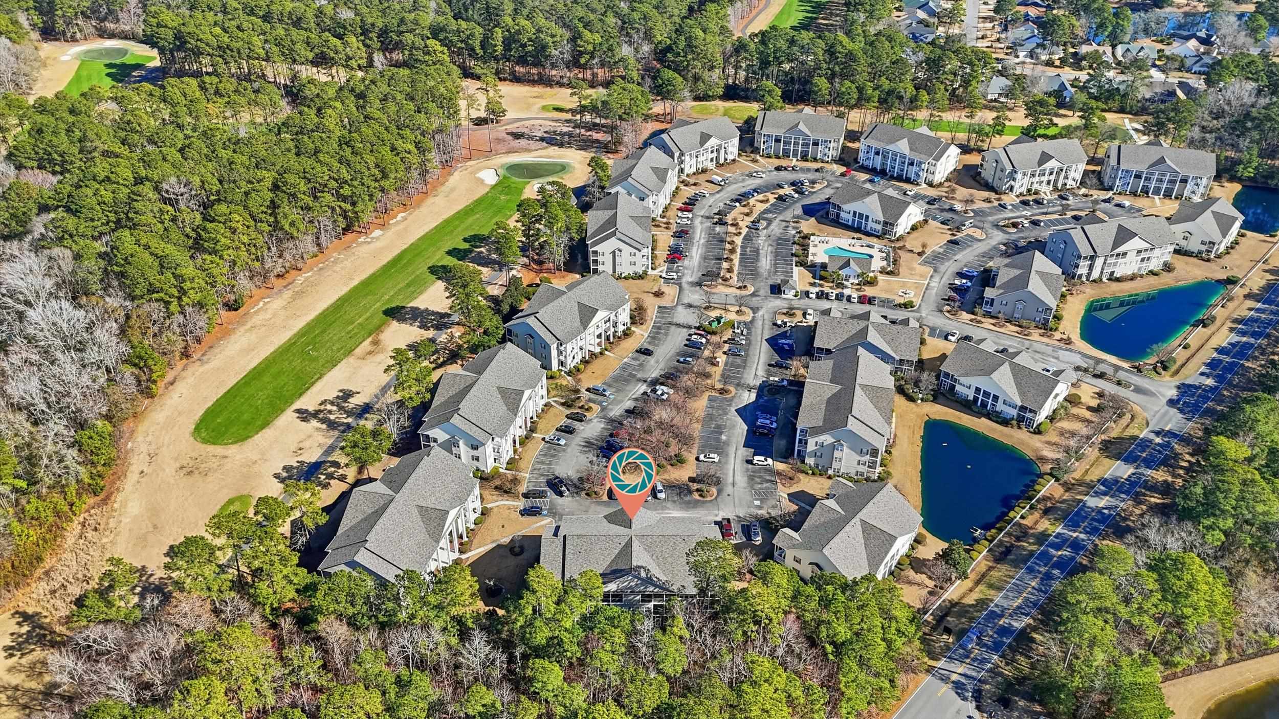 5870 Longwood Drive, Unit 203 Murrells Inlet, SC 29576 - Photo 31 of 32 Aerial view of property and surrounding area featuring a nearby body of water and nearby suburban area