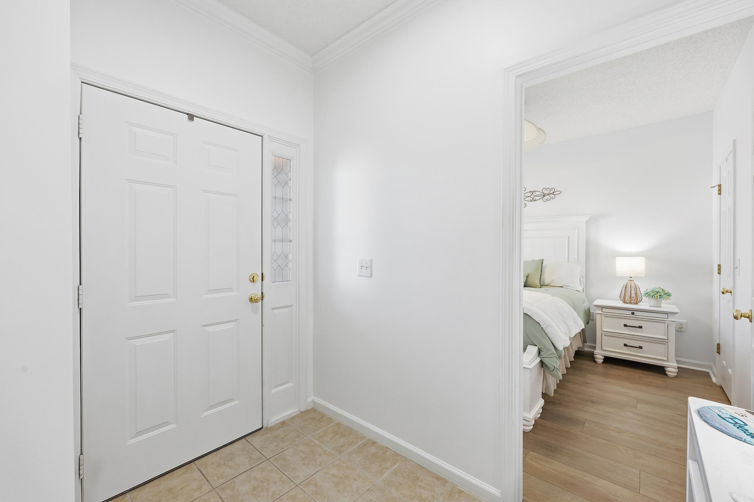 5870 Longwood Drive, Unit 203 Murrells Inlet, SC 29576 - Photo 4 of 32 Foyer entrance with ornamental molding and light tile patterned flooring